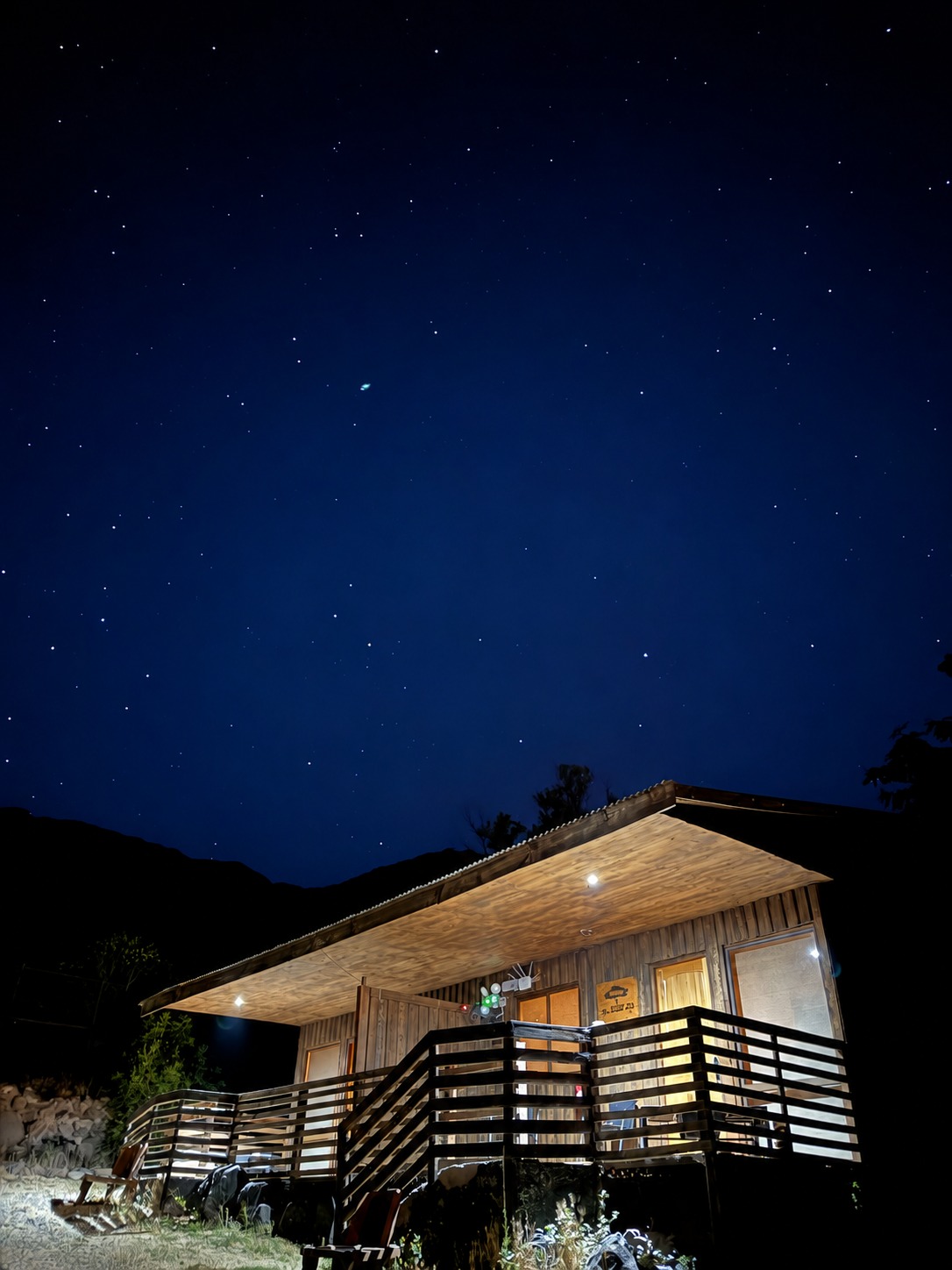 Cayumanque cabin lit up beneath the starry sky of Cajón del Maipo