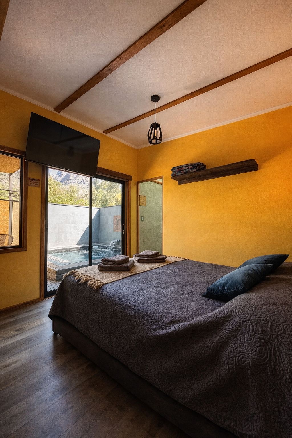 Suite bedroom with the private jacuzzi pool next to the sliding glass door